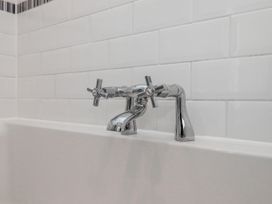 A faucet with handles above a bathtub at The Arches in Torquay