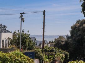 A view of the ocean and trees at The Arches in Torquay