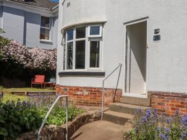 An entrance with steps and flowers at The Arches in Torquay