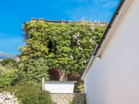 A building covered in vegetation at The Arches in Torquay