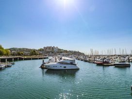 A marina with boats and buildings at The Arches in Torquay