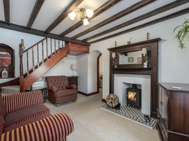 A living room with a stair and fireplace at Preswylfa