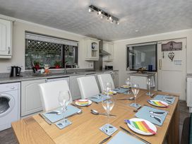 A kitchen with dining table set at Preswylfa