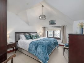 A bedroom with a bed and furniture at Preswylfa 