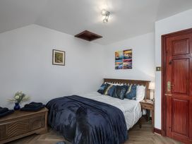 A bedroom with a bed and bedside table at Preswylfa