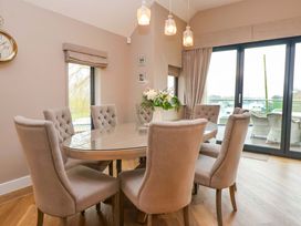 A dining room with a table and chairs at Swing Bridge Cottage