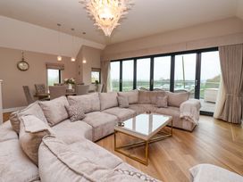 A living room with a sofa and coffee table at Swing Bridge Cottage