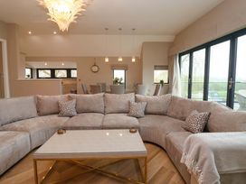 A living room with a sofa and coffee table at Swing Bridge Cottage