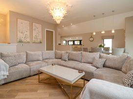 A living room with a sofa and coffee table at Swing Bridge Cottage