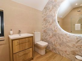 A bathroom with a vanity and toilet at Swing Bridge Cottage