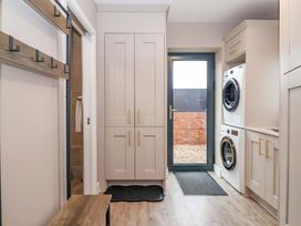 A laundry room with washing machine and dryer at Swing Bridge Cottage
