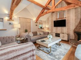 A living room with a sofa and coffee table at Mill Race Cottage Driffield