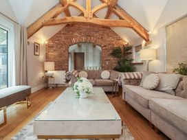 A living room with seating and a coffee table at Mill Race Cottage in Driffield