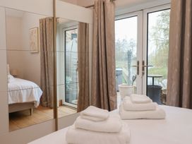 A bedroom with a bed and towels on the bed at Mill Race Cottage in Driffield