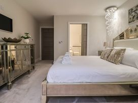 A bedroom with a bed and a television at Mill Race Cottage in Driffield