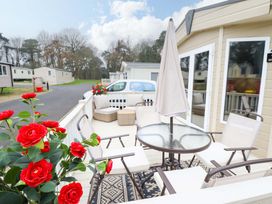 An outdoor patio with a table and chairs at 108 Fox Burrow Hang in Great Yarmouth
