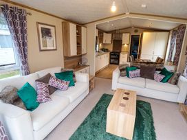 A living room with sofas and a coffee table at 108 Fox Burrow Hang in Great Yarmouth