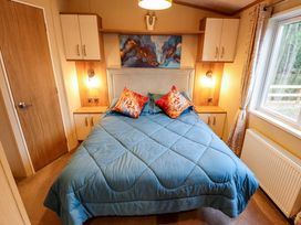 A bedroom with a bed and wardrobe at 108 Fox Burrow Hang in Great Yarmouth