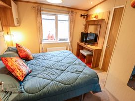 A bedroom with a bed and television at 108 Fox Burrow Hang in Great Yarmouth