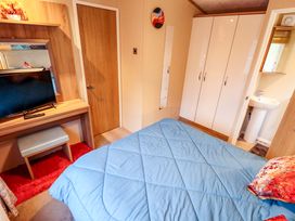 A bedroom with a bed and television at 108 Fox Burrow Hang in Great Yarmouth