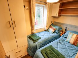 A bedroom with two beds and a wardrobe at 108 Fox Burrow Hang in Great Yarmouth