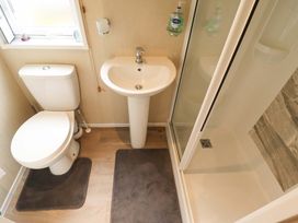 A bathroom with a toilet, sink, and shower at 108 Fox Burrow Hang in Great Yarmouth