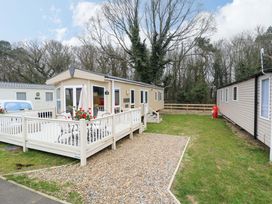 A caravan with decking and outdoor seating at 108 Fox Burrow Hang Great Yarmouth