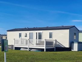 A mobile home with a deck and steps at 18 Fallows Fall in Leven