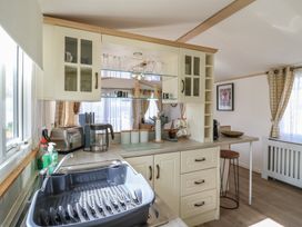 A kitchen with sink, countertop, and appliances at 2 bed Caravan Stowmarket