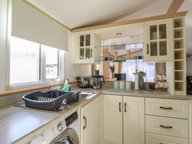 A kitchen with appliances and utensils at 2 bed Caravan Stowmarket