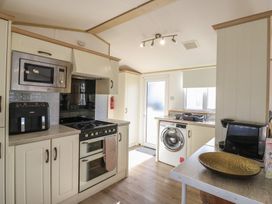 A kitchen with appliances and a sink at 2 bed Caravan Stowmarket