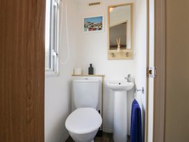 A bathroom with a toilet and sink at 2 bed Caravan in Stowmarket
