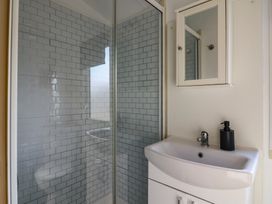 A bathroom with a shower and sink at 2 bed Caravan Stowmarket