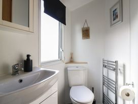 A bathroom with a sink, toilet, and towel rail at 2 bed Caravan Stowmarket
