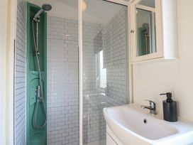 A bathroom with a shower and sink at 2 bed Caravan in Stowmarket