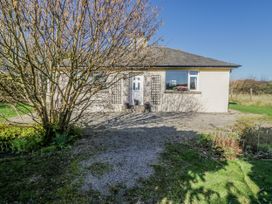 A house with a gravel pathway and tree at Linden Lea Grange-Over-Sands