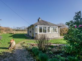 A house with windows and a dog in the garden at Linden Lea Grange-Over-Sands