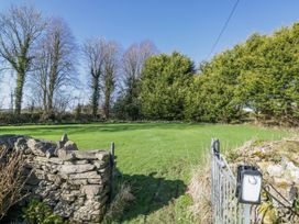 A garden with grass and trees at Linden Lea Grange-Over-Sands