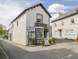 A corner building with signage at Cartmel in Grange-Over-Sands