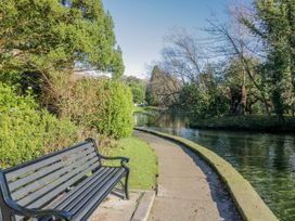 A park with a bench and a path along the water at Linden Lea in Grange-Over-Sands