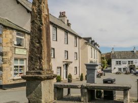 A street scene with buildings and a stone pillar at Linden Lea Grange-Over-Sands