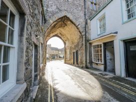 An archway leading to a street with buildings in Grange-Over-Sands