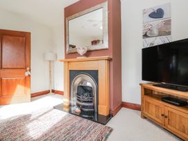 A living room with a fireplace and television at Linden Lea Field Broughton near Cartmel