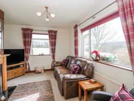 A living room with a sofa and television at Linden Lea Field Broughton near Cartmel