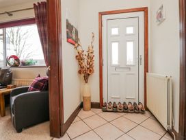 A hallway with a front door and a decorative vase at Linden Lea Field Broughton near Cartmel