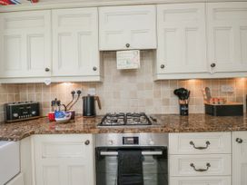 A kitchen with stove and cabinets at Linden Lea Field Broughton near Cartmel