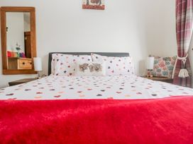A bedroom with a bed and decorative pillows at Linden Lea Field Broughton near Cartmel