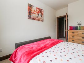 A bedroom with a bed and dresser at Linden Lea Field Broughton near Cartmel
