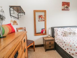 A bedroom with a bed and bedside table at Linden Lea Field Broughton near Cartmel