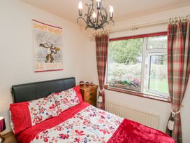 A bedroom with a bed and window at Linden Lea Field Broughton near Cartmel